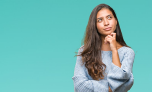 Woman looking off to the side, considering dental sedation